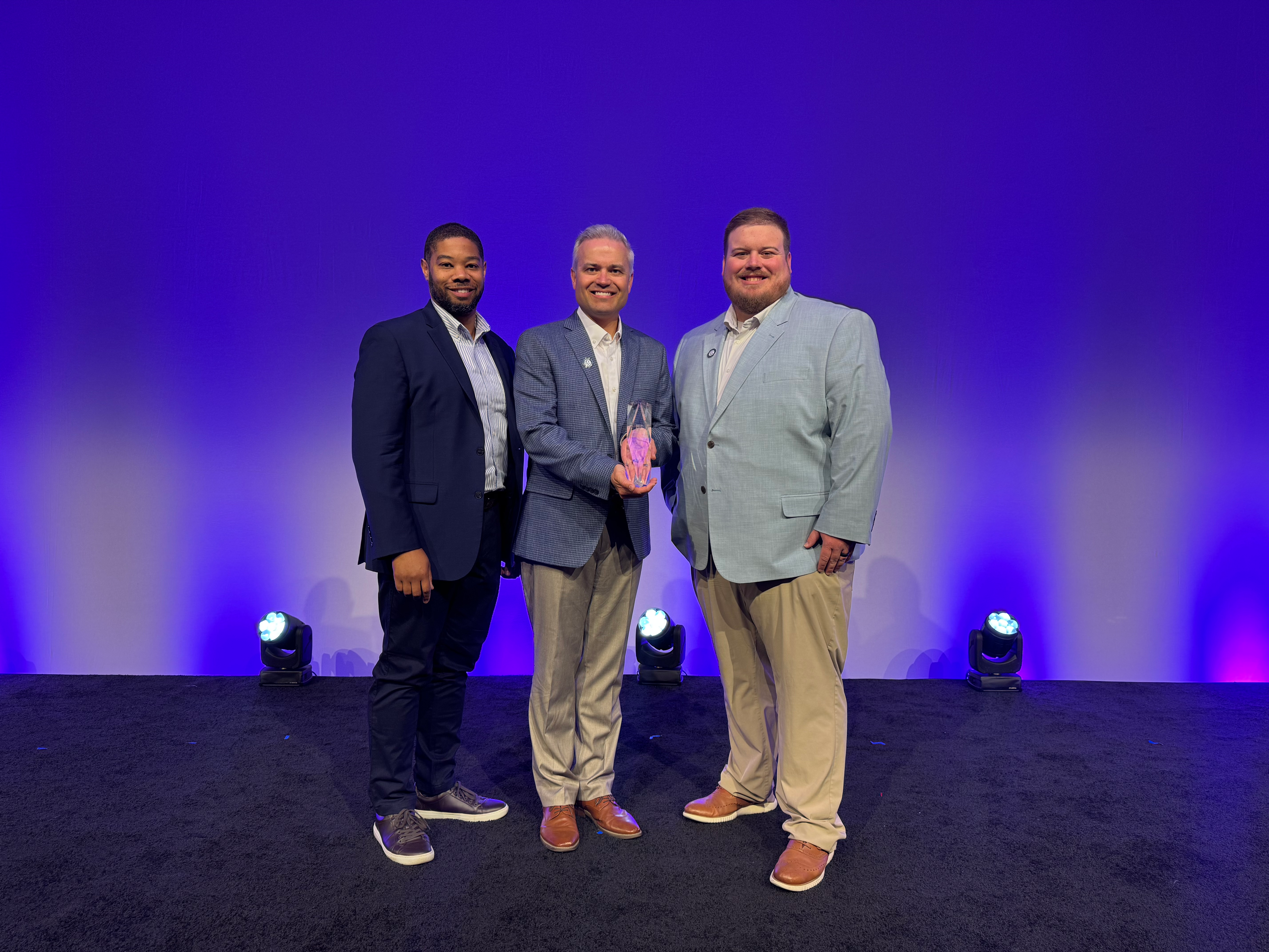 Clarkson Construction Company Accepts National Safety Award Photo of three people holdig safety award